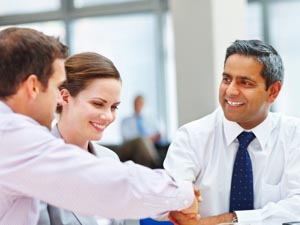 Three people, two shaking hands