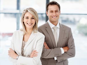 Two staff members smiling